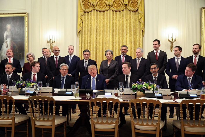 Photo de Donald Trump assis à une table entouré de beaucoup d'hommes et de deux femmes.